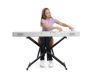 Photo of Cute girl playing synthesizer on white background