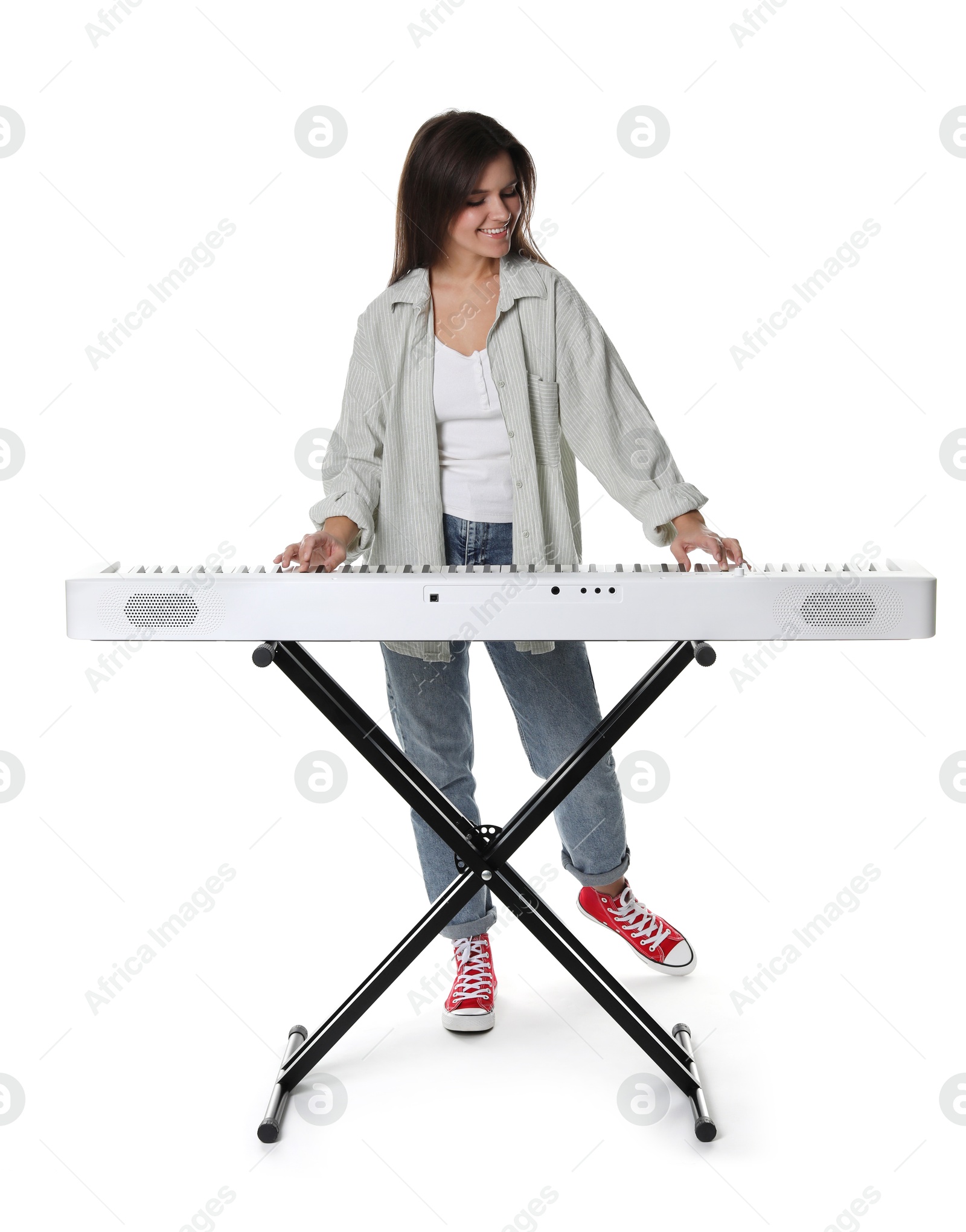 Photo of Smiling woman playing synthesizer on white background