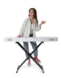 Smiling woman playing synthesizer on white background