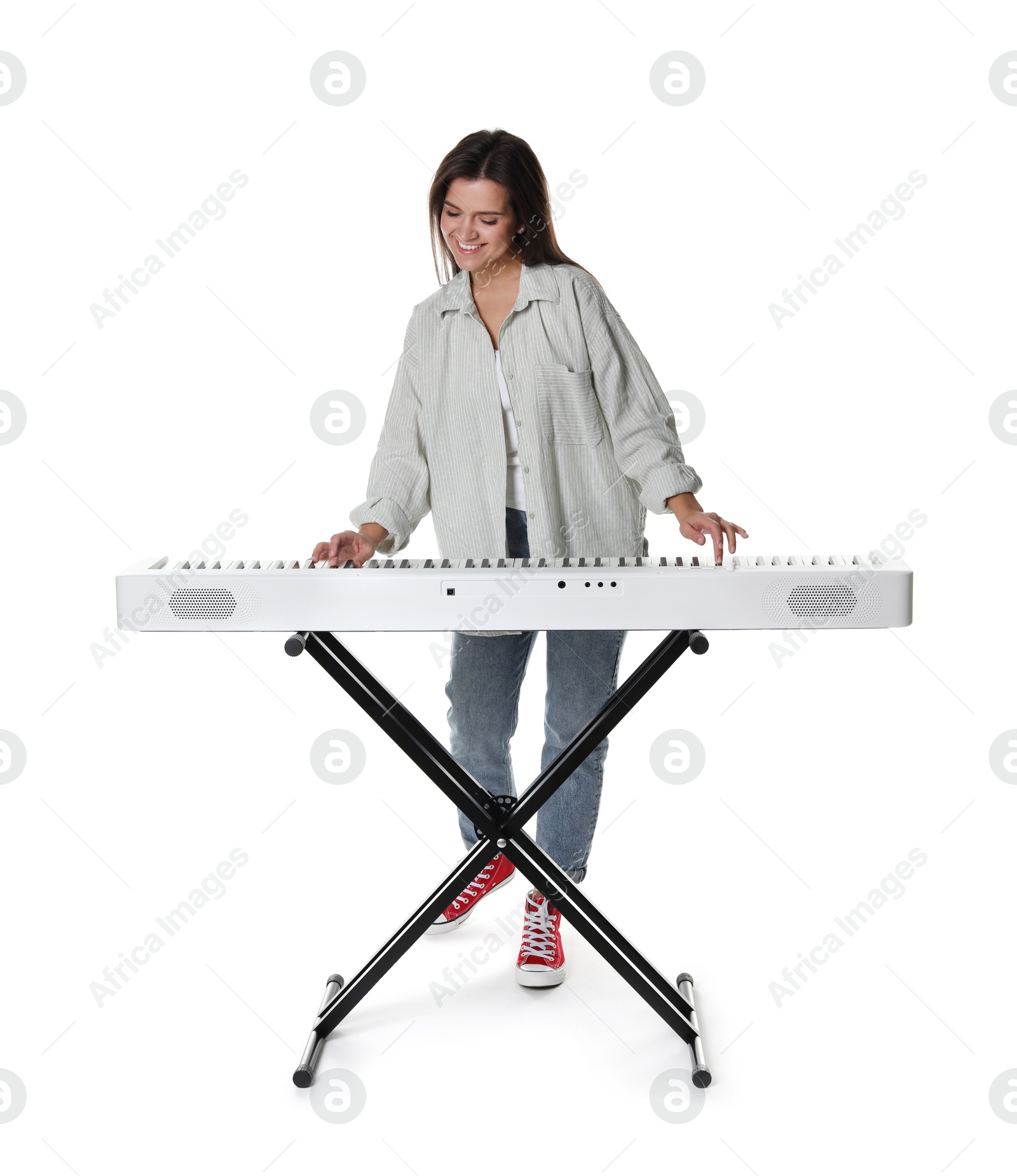 Photo of Smiling woman playing synthesizer on white background