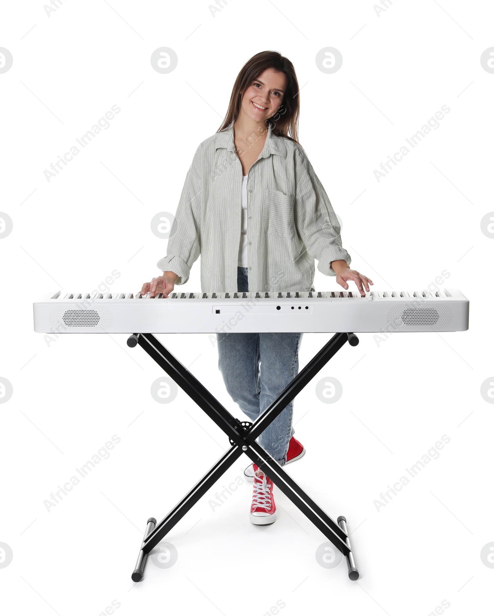 Photo of Smiling woman playing synthesizer on white background