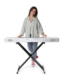 Photo of Smiling woman playing synthesizer on white background