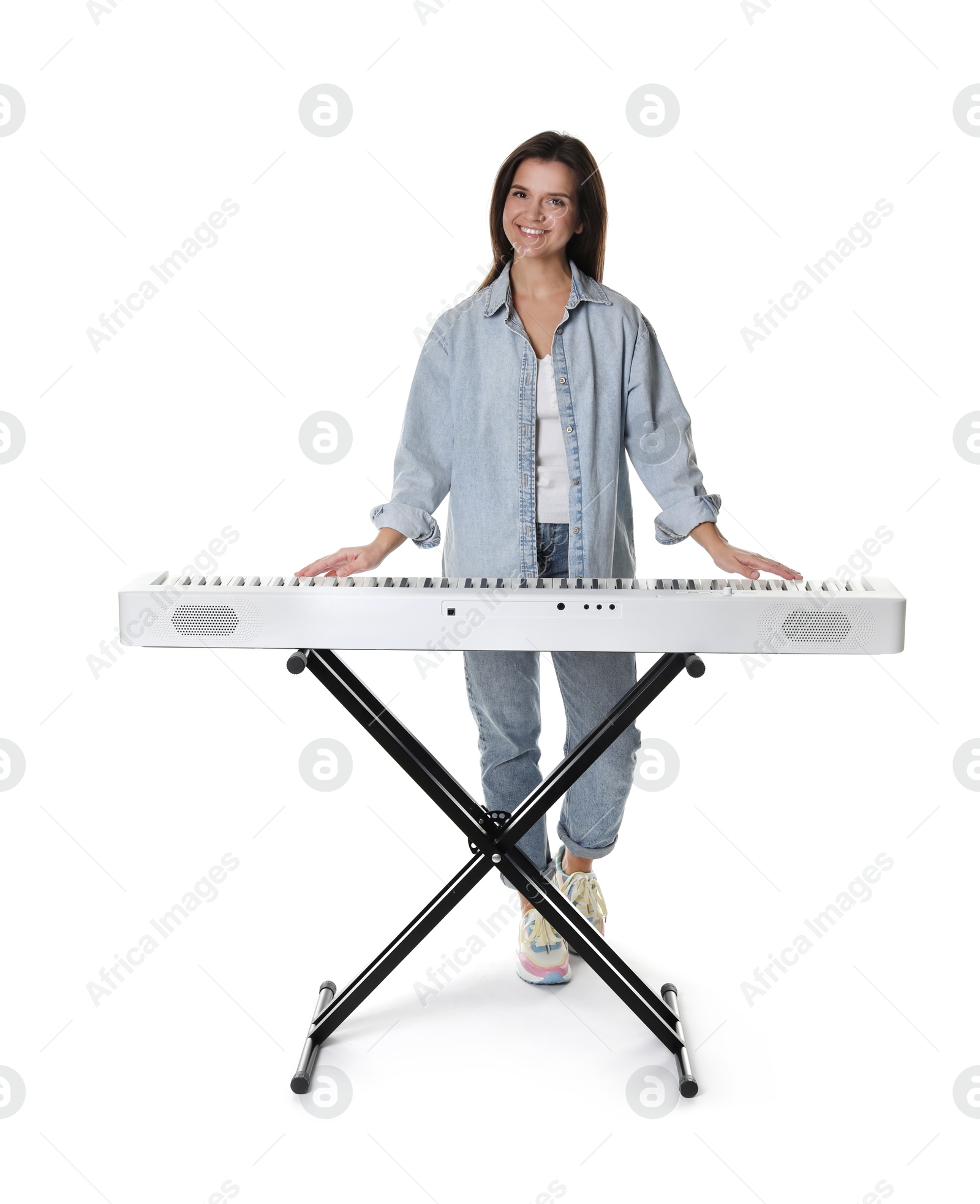 Photo of Smiling woman playing synthesizer on white background