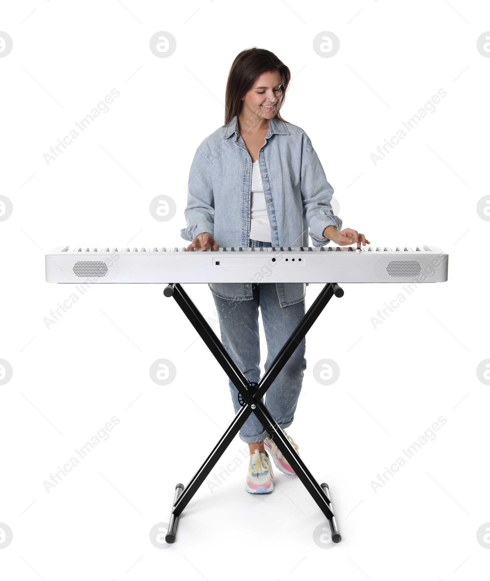 Photo of Smiling woman playing synthesizer on white background