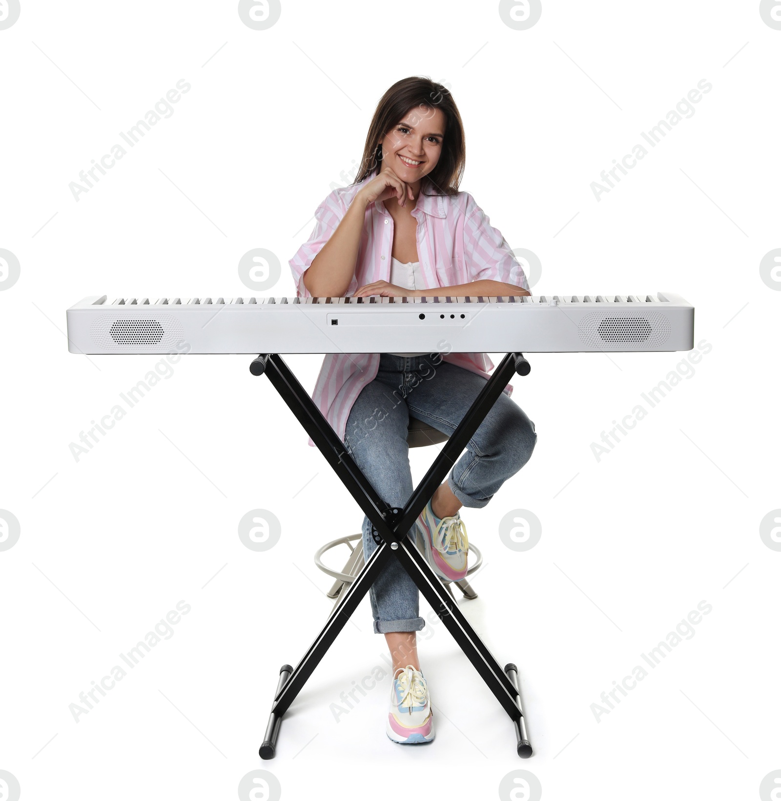 Photo of Beautiful woman posing with synthesizer on white background