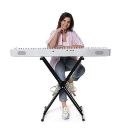 Beautiful woman posing with synthesizer on white background