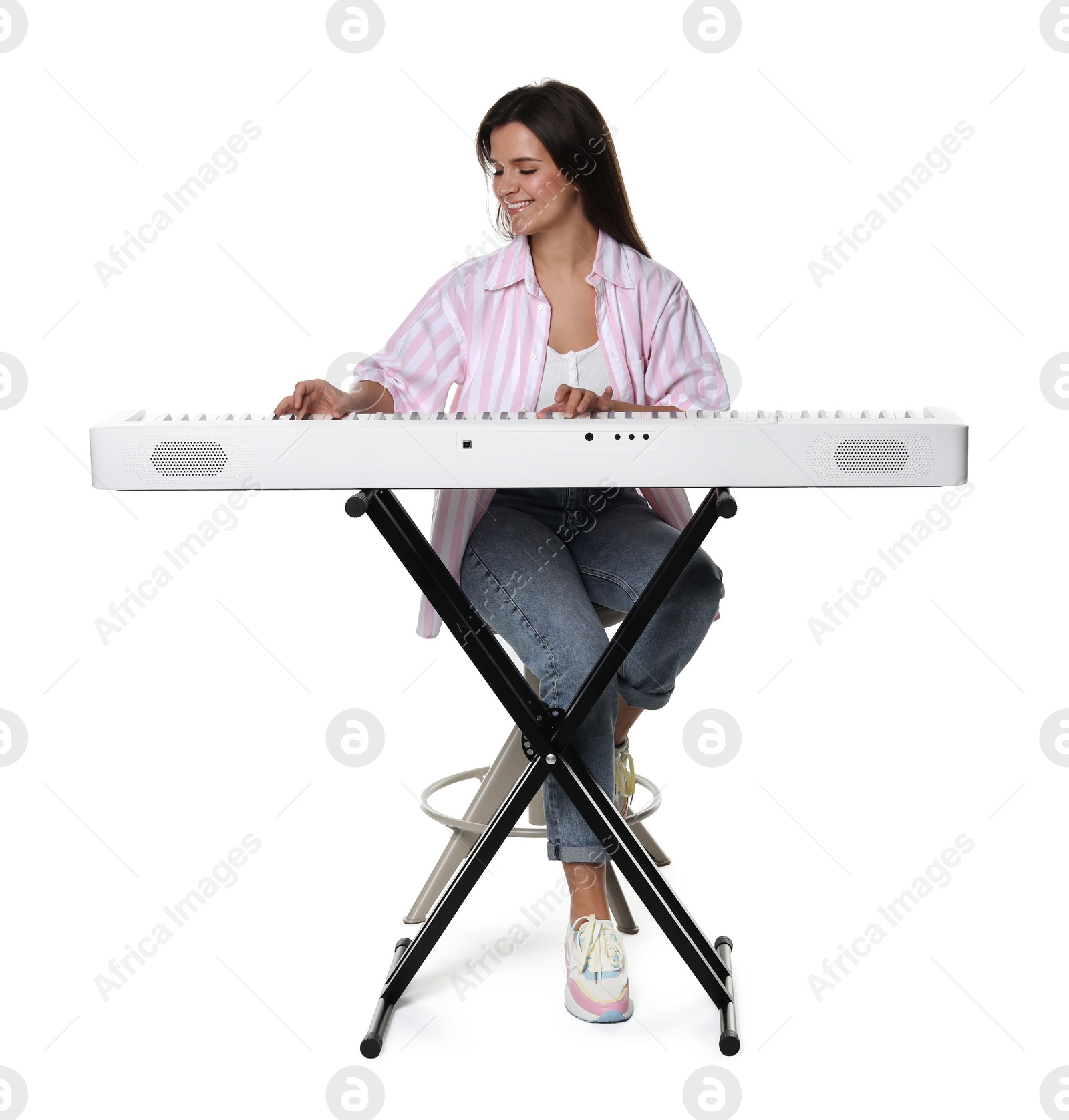 Photo of Smiling woman playing synthesizer on white background