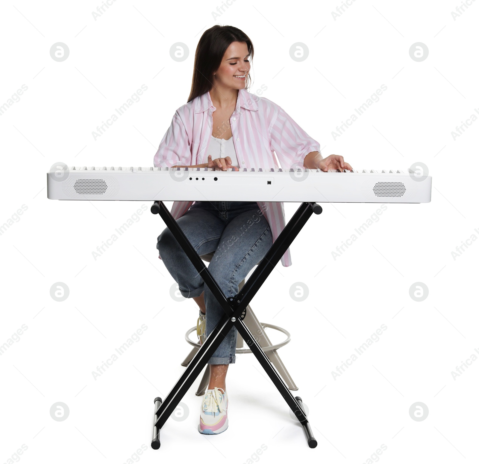 Photo of Smiling woman playing synthesizer on white background