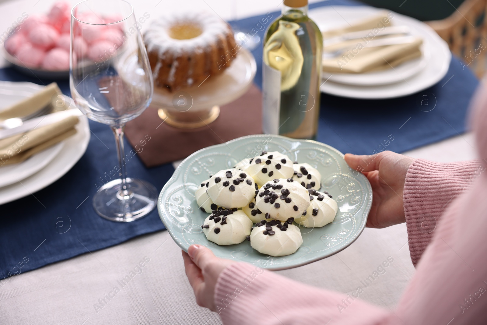 Photo of Woman setting table for dinner at home, closeup