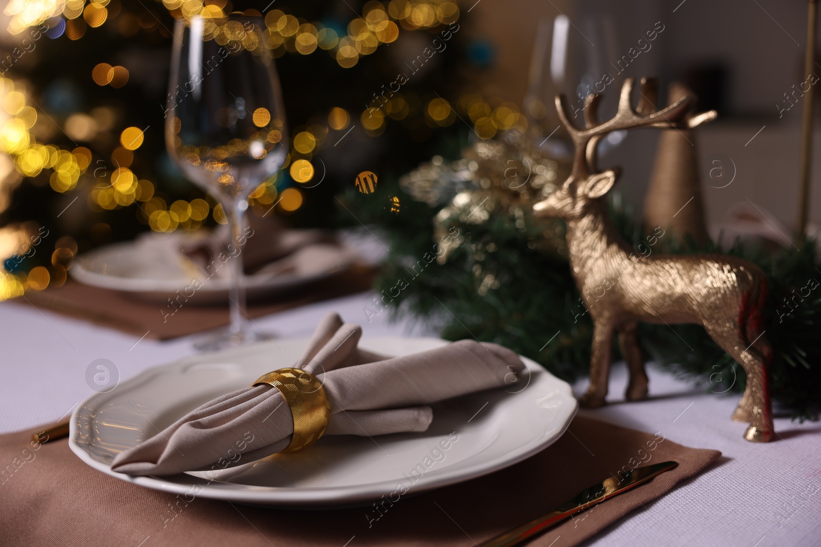 Photo of Festive table setting with dishware, glasses and decor indoors, closeup