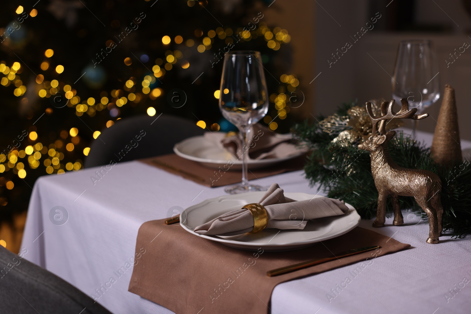 Photo of Festive table setting with dishware, glasses and decor indoors