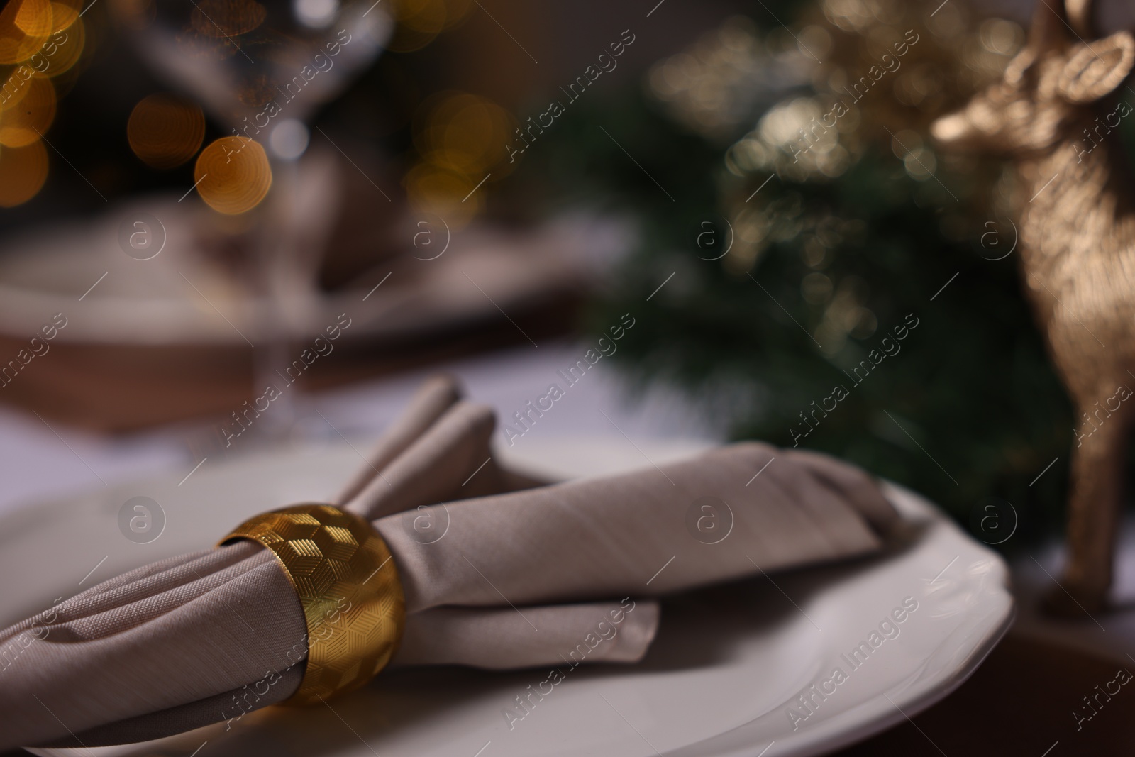 Photo of Festive table setting with plate, napkin and decor indoors, closeup