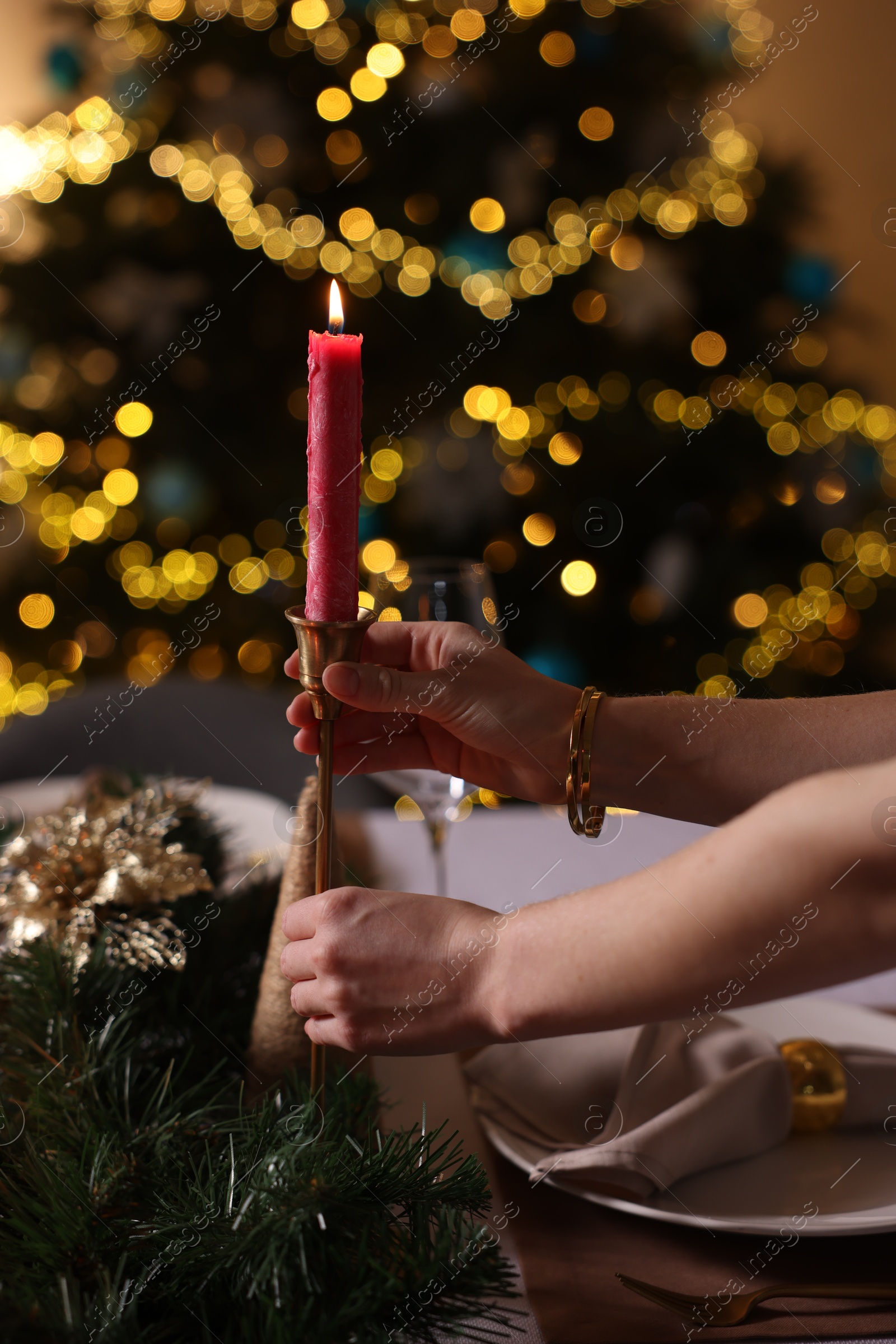 Photo of Woman setting table for Christmas dinner at home, closeup