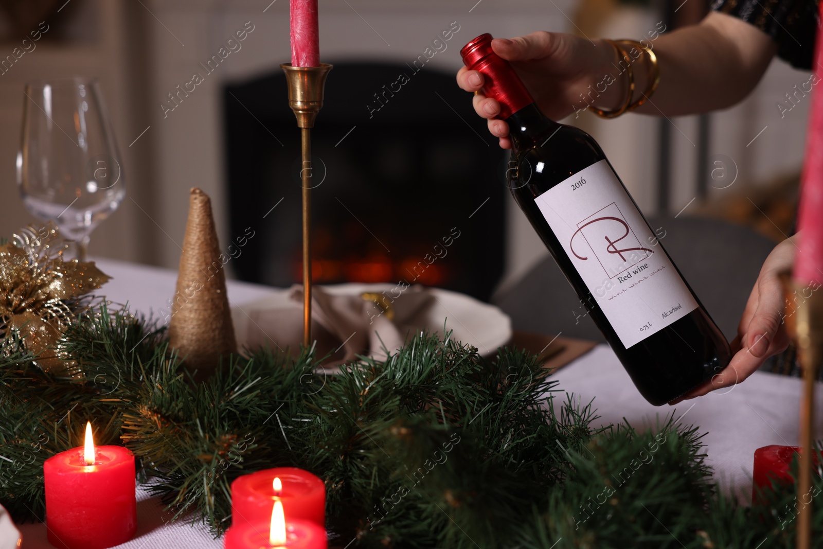 Photo of Woman setting table for Christmas dinner at home, closeup