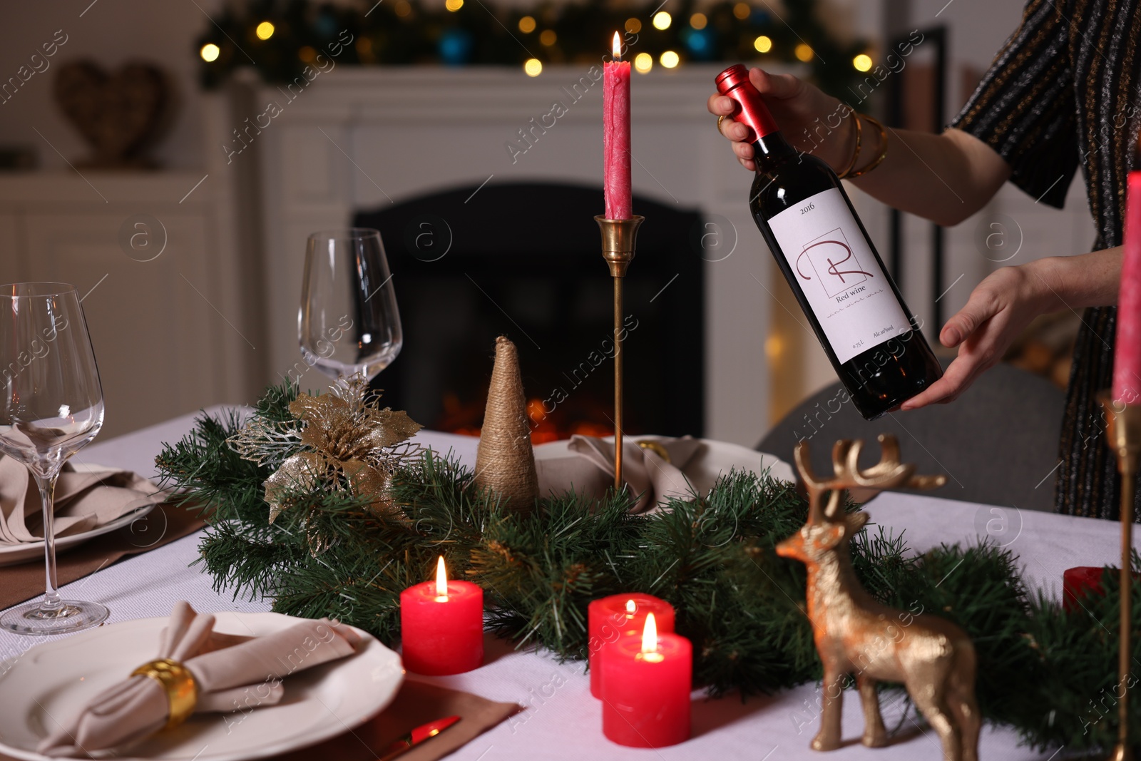 Photo of Woman setting table for Christmas dinner at home, closeup