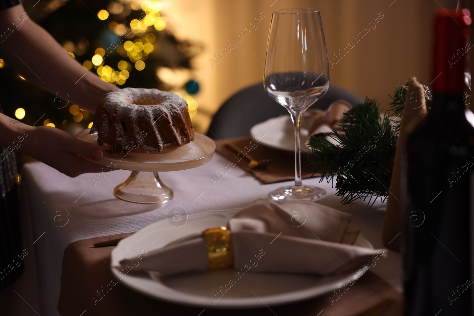 Photo of Woman setting table for Christmas dinner at home, closeup