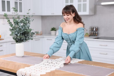 Photo of Woman setting table for dinner at home