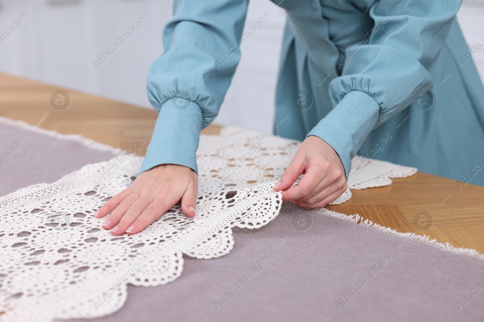 Photo of Woman setting table for dinner at home, closeup