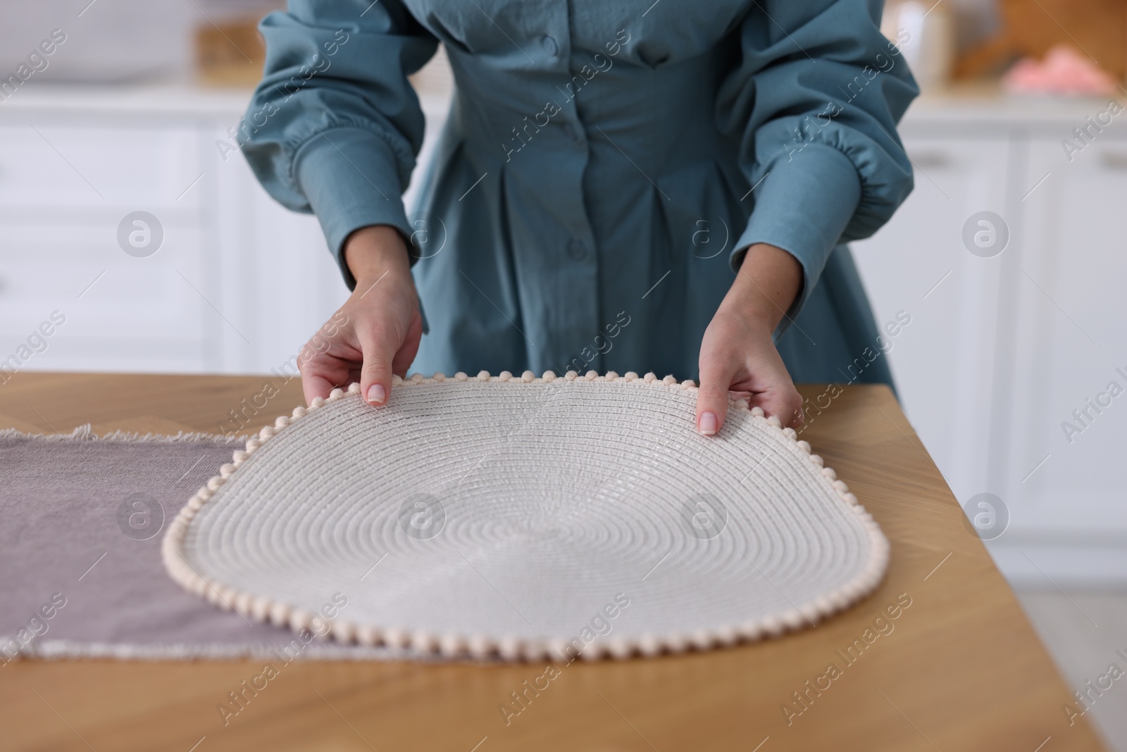 Photo of Woman setting table for dinner at home, closeup