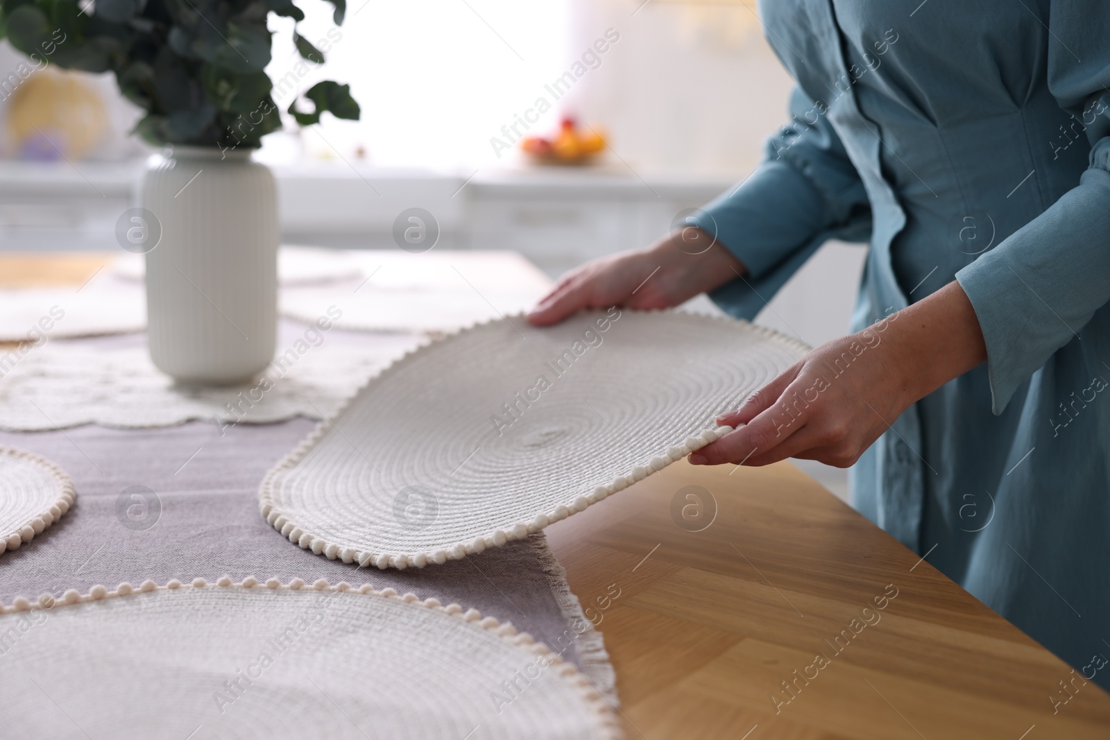 Photo of Woman setting table for dinner at home, closeup