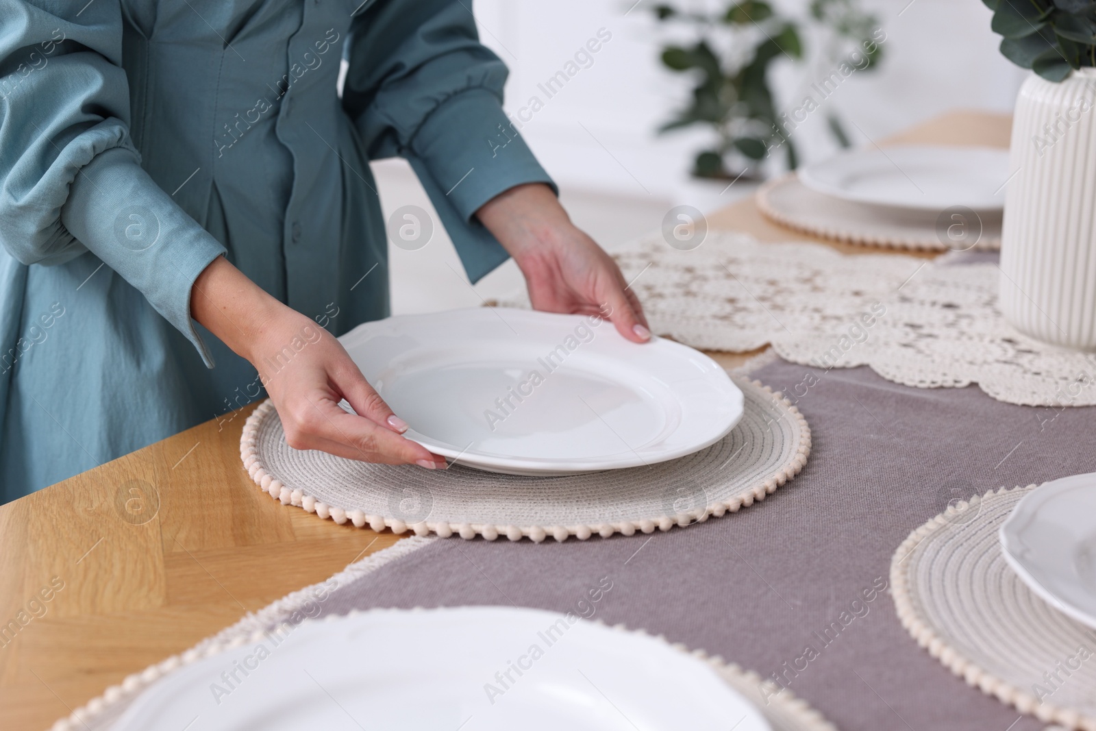 Photo of Woman setting table for dinner at home, closeup