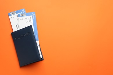 Photo of Travel agency. Flight tickets and passport on orange background, top view. Space for text