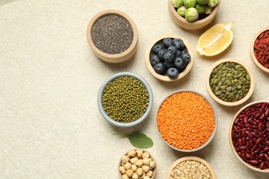 Photo of Different superfood products on light table, flat lay. Space for text