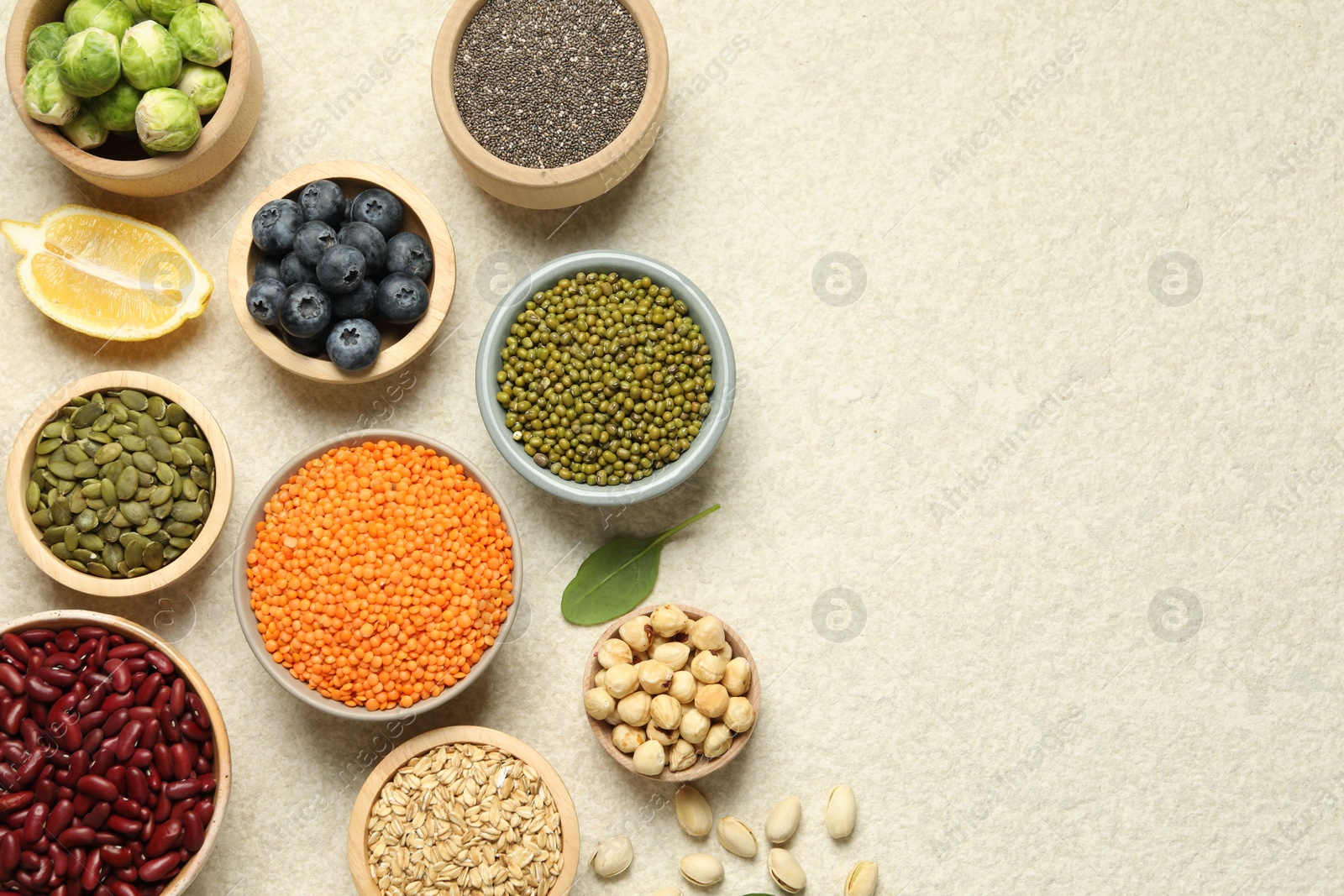 Photo of Different superfood products on light table, flat lay. Space for text