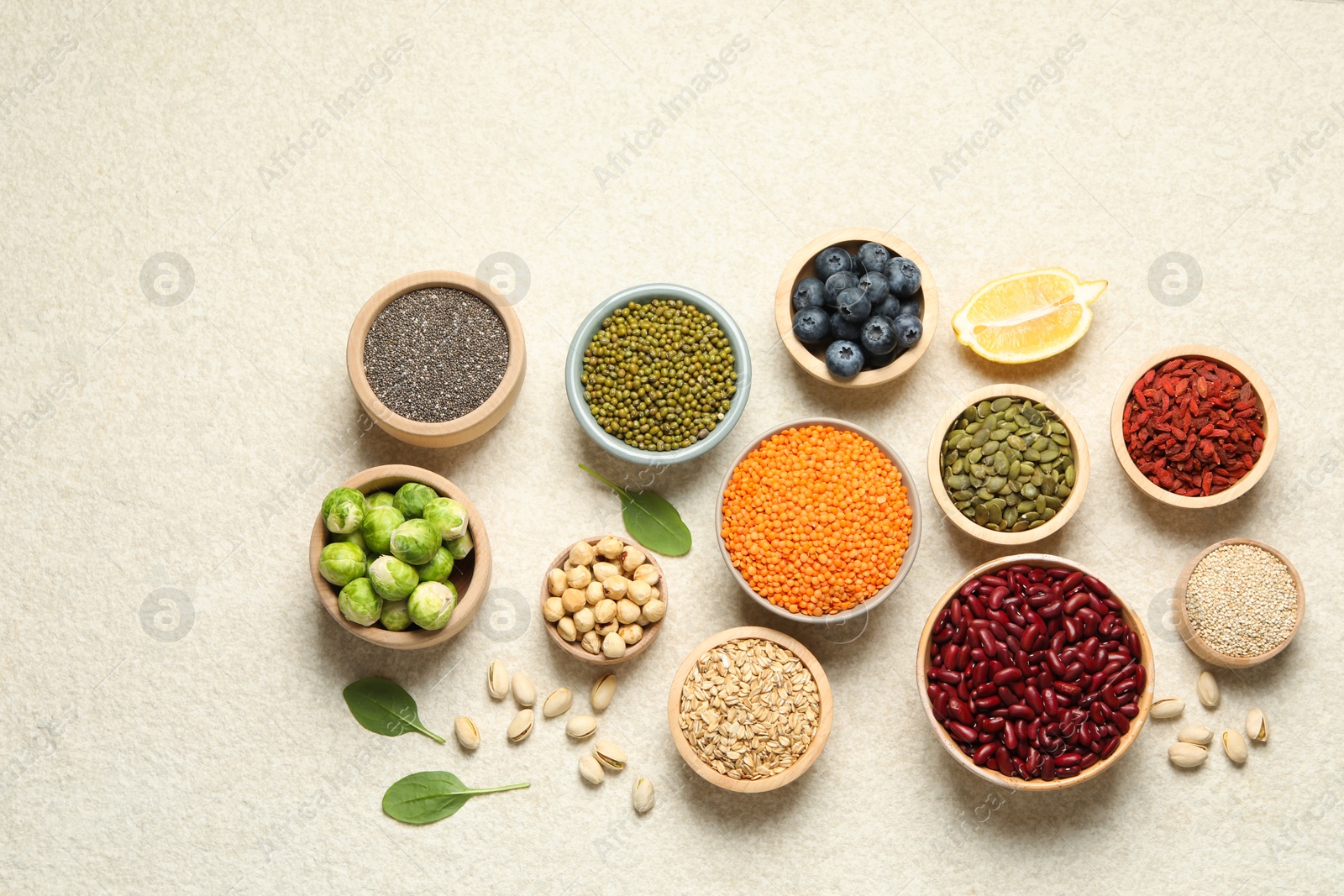 Photo of Different superfood products on light table, flat lay. Space for text