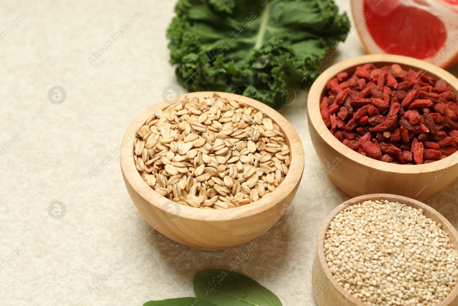 Photo of Different superfood products on light table, closeup