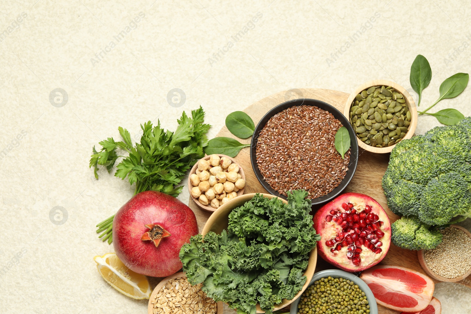 Photo of Different superfood products on light table, top view. Space for text