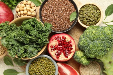 Photo of Different superfood products on light table, closeup