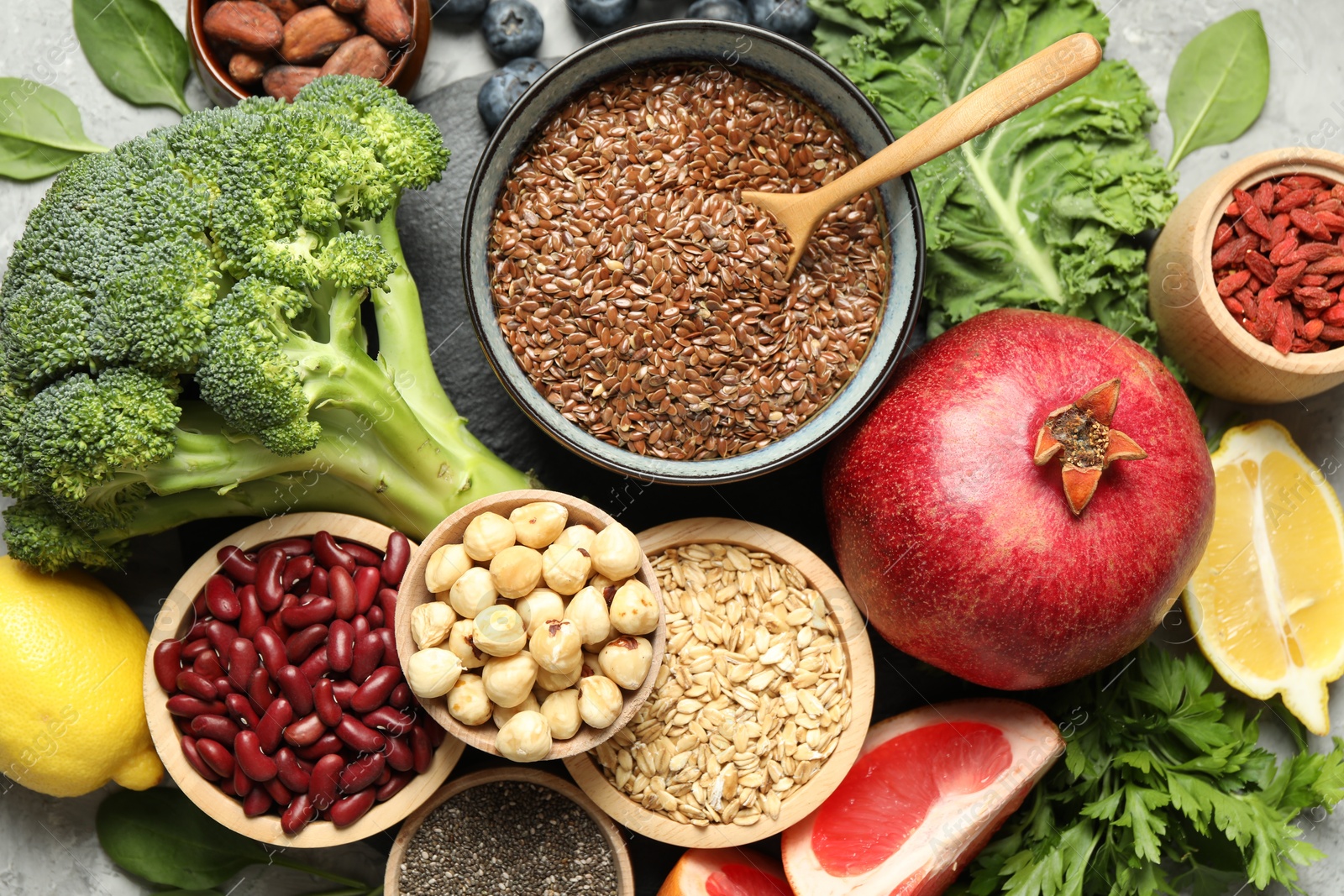 Photo of Different superfood products on grey table, top view