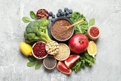 Photo of Different superfood products on grey table, flat lay