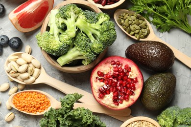 Photo of Different superfood products on grey table, flat lay