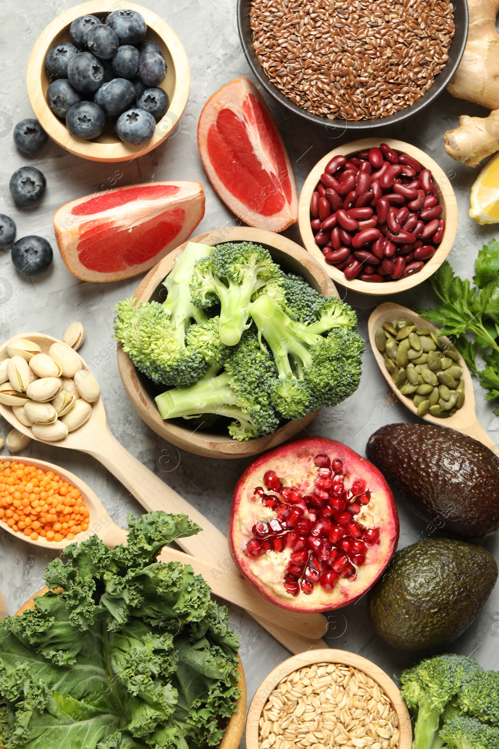 Photo of Different superfood products on grey table, flat lay