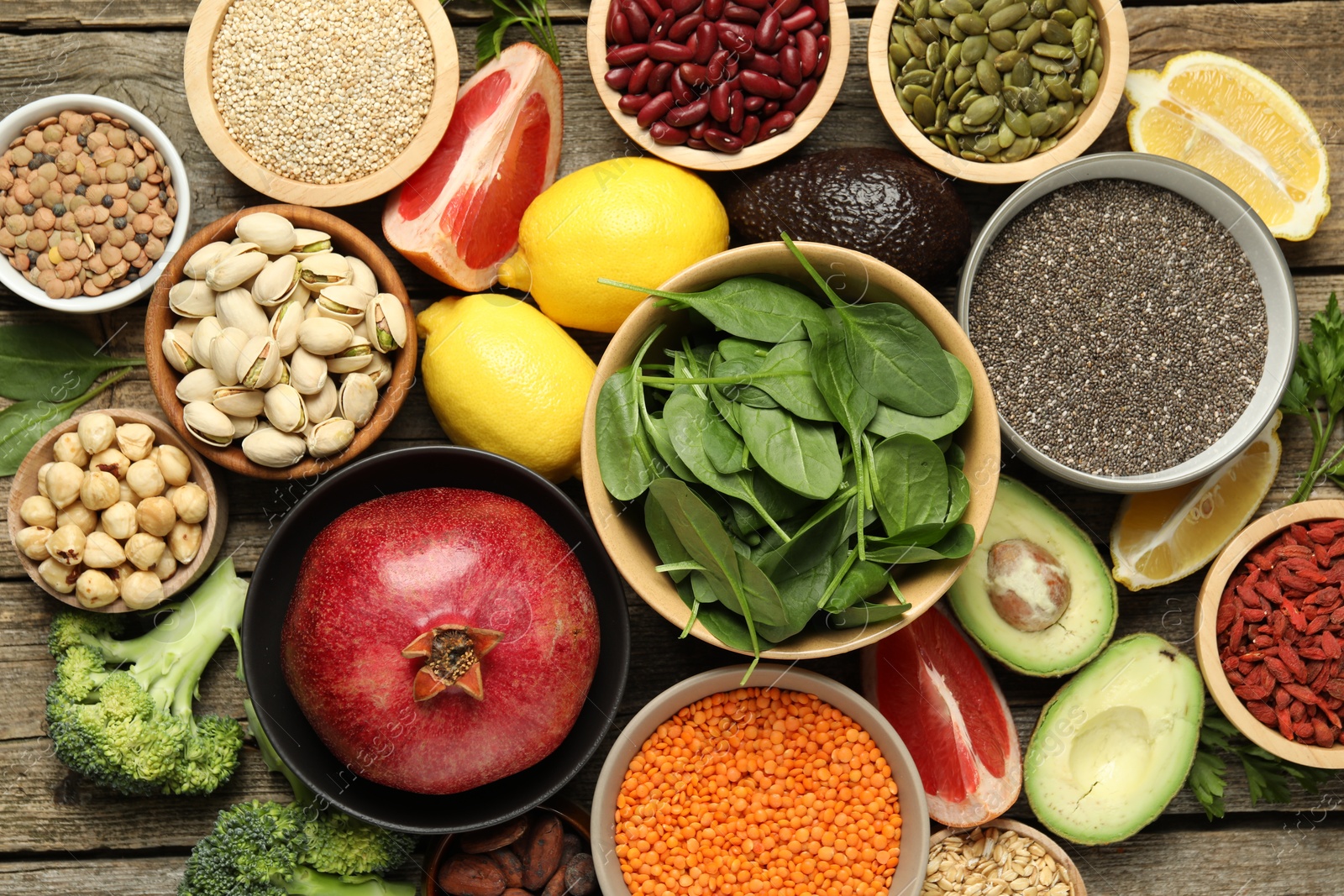 Photo of Different superfood products on wooden table, flat lay