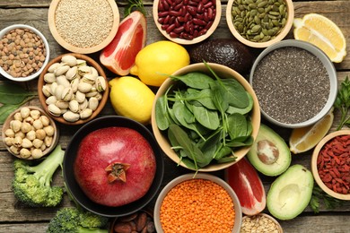 Photo of Different superfood products on wooden table, flat lay