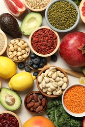 Photo of Different superfood products on white table, flat lay