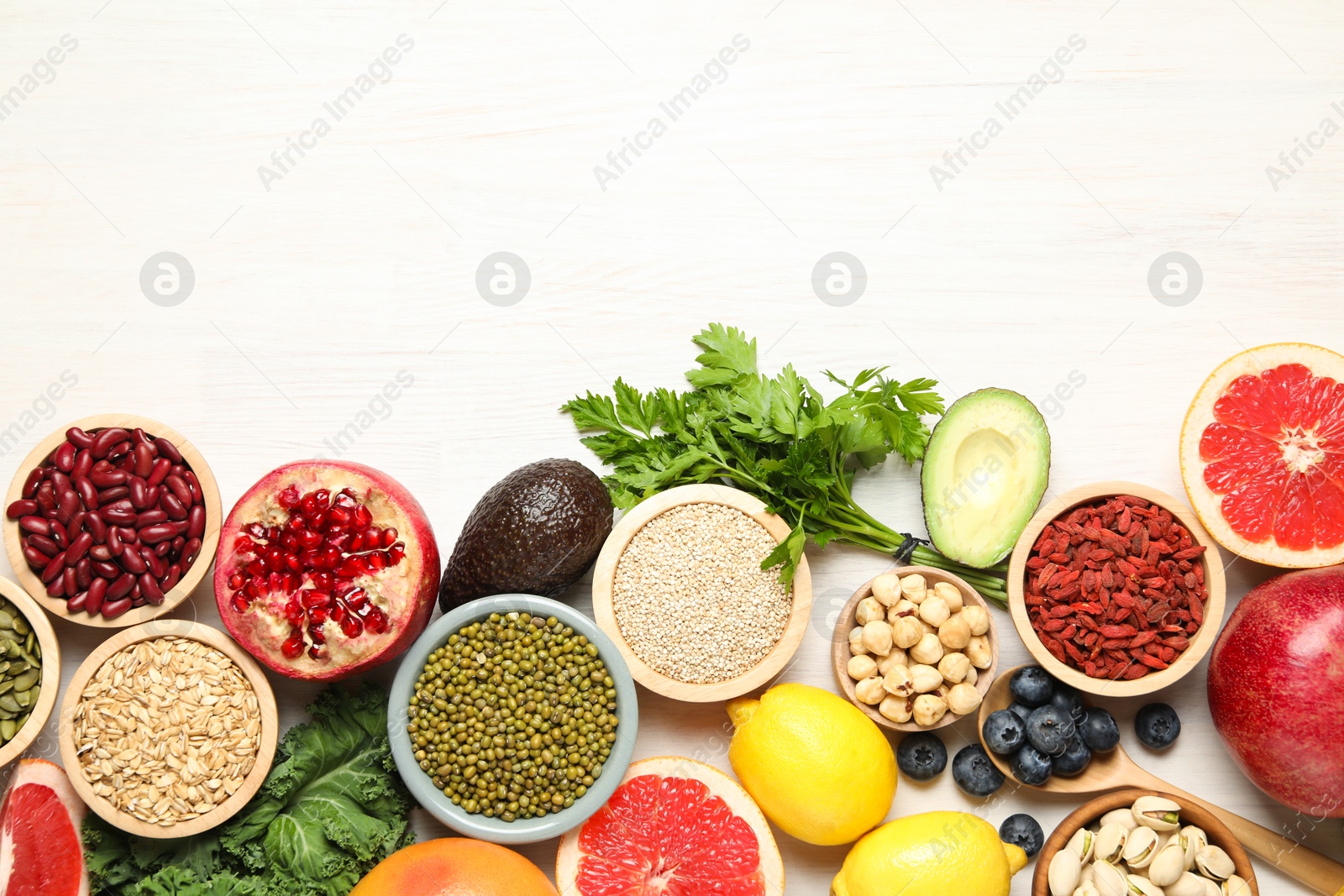 Photo of Different superfood products on white table, flat lay. Space for text