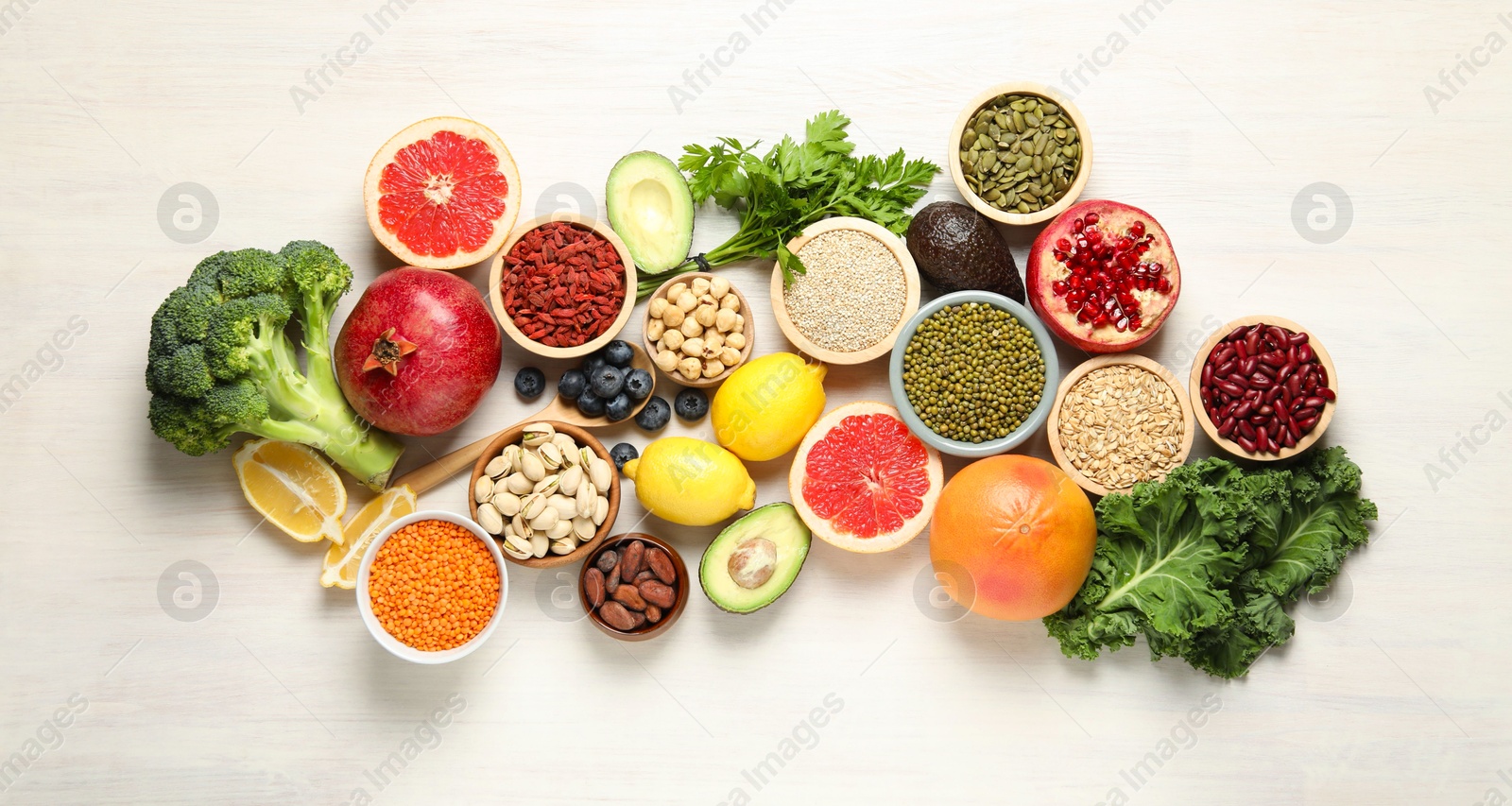 Photo of Different superfood products on white table, flat lay