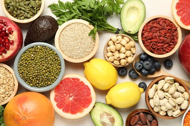 Photo of Different superfood products on white table, flat lay