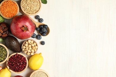 Photo of Different superfood products on white table, flat lay. Space for text