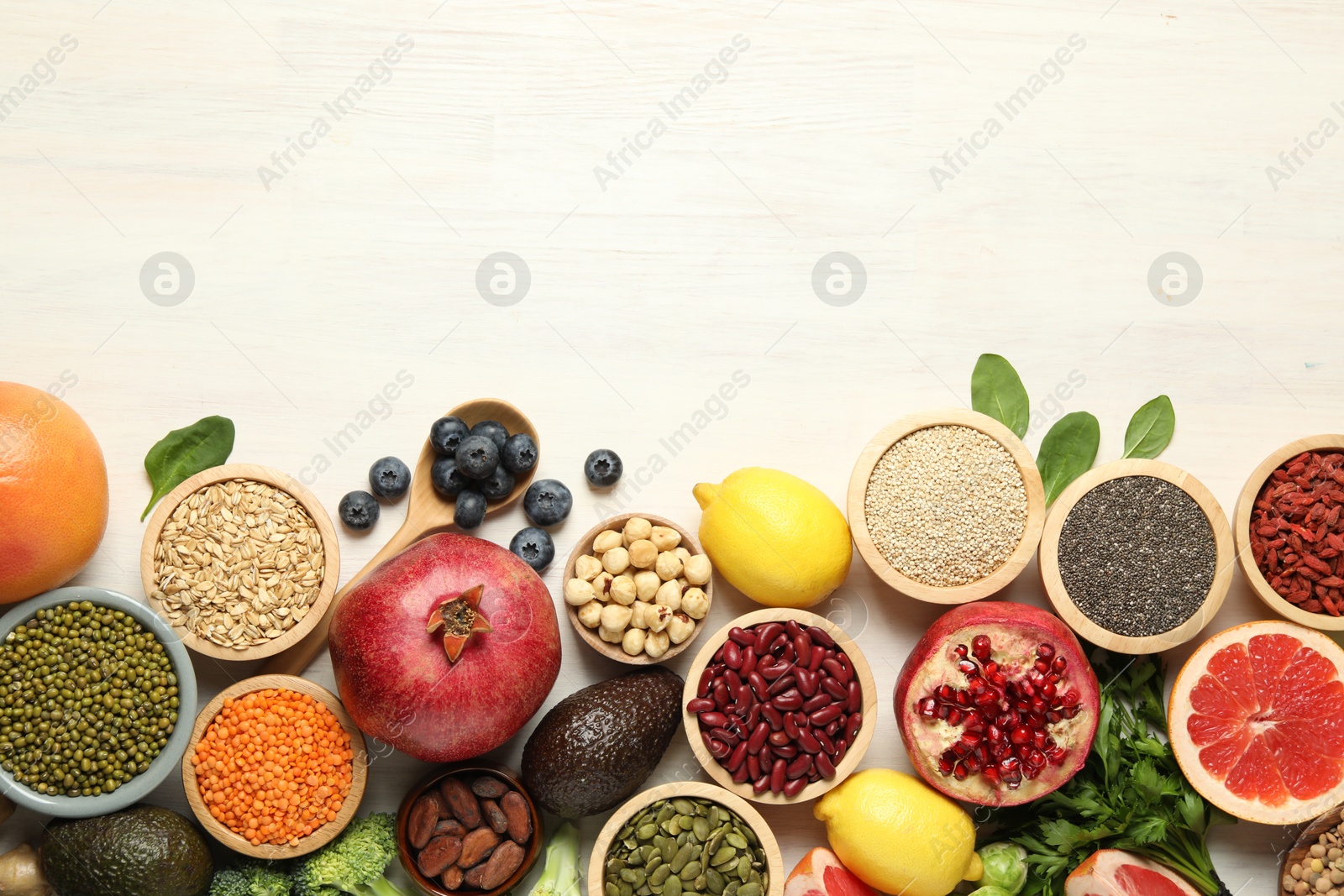 Photo of Different superfood products on white table, flat lay. Space for text