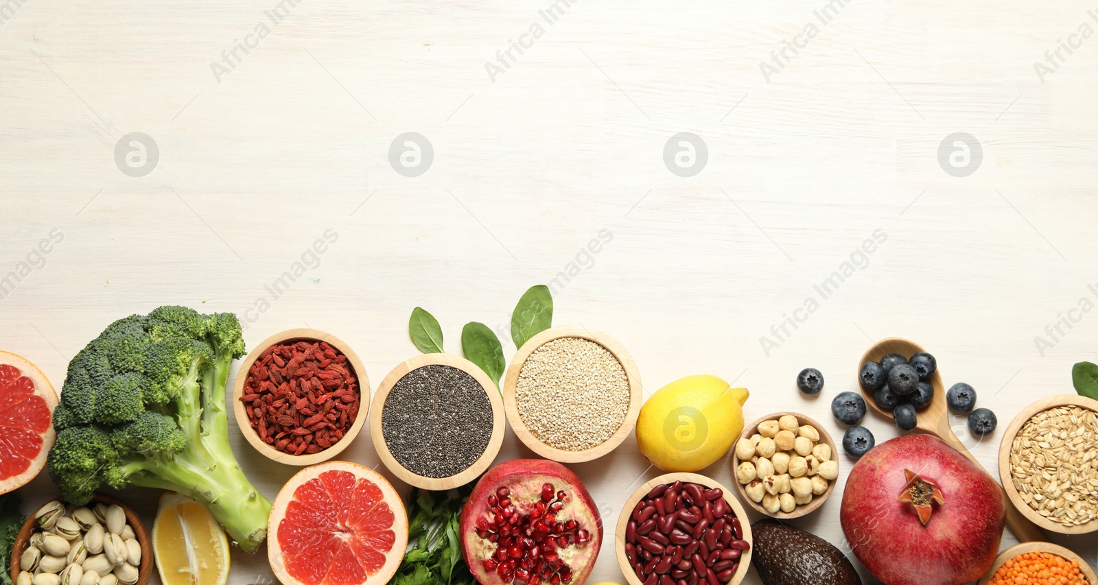 Photo of Different superfood products on white table, flat lay. Space for text