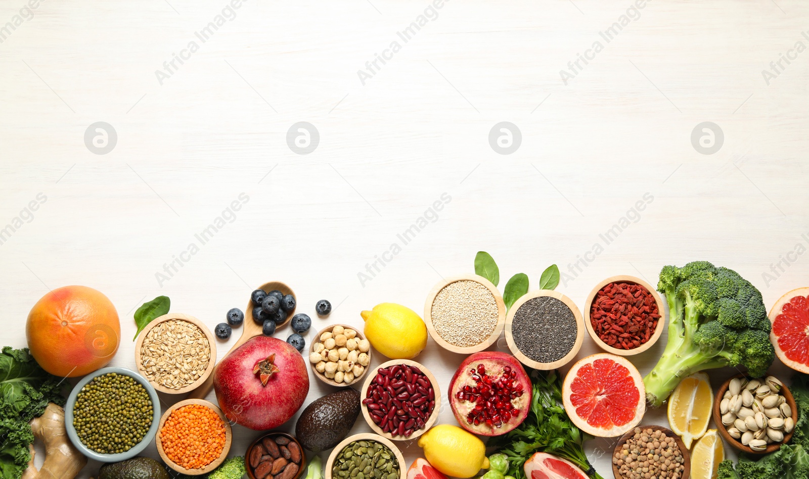 Photo of Different superfood products on white table, flat lay. Space for text