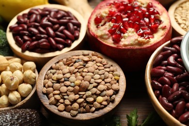 Photo of Different superfood products on wooden table, closeup