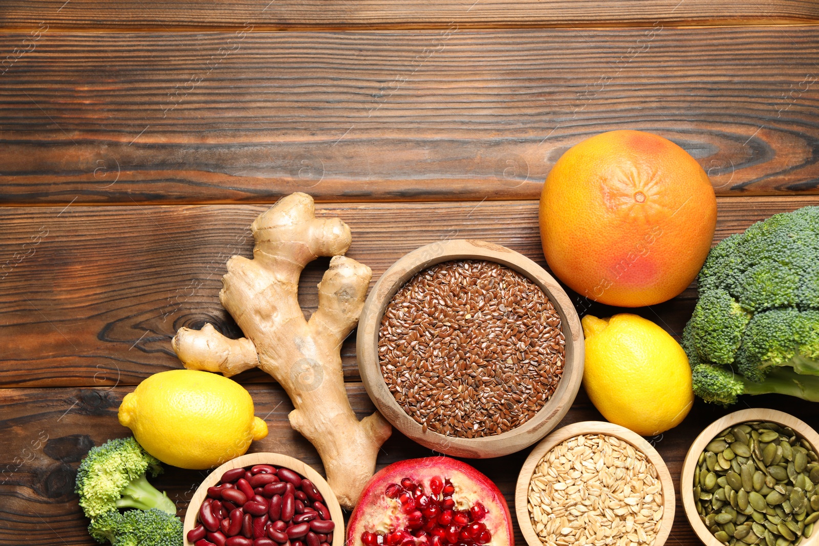 Photo of Different superfood products on wooden table, flat lay. Space for text