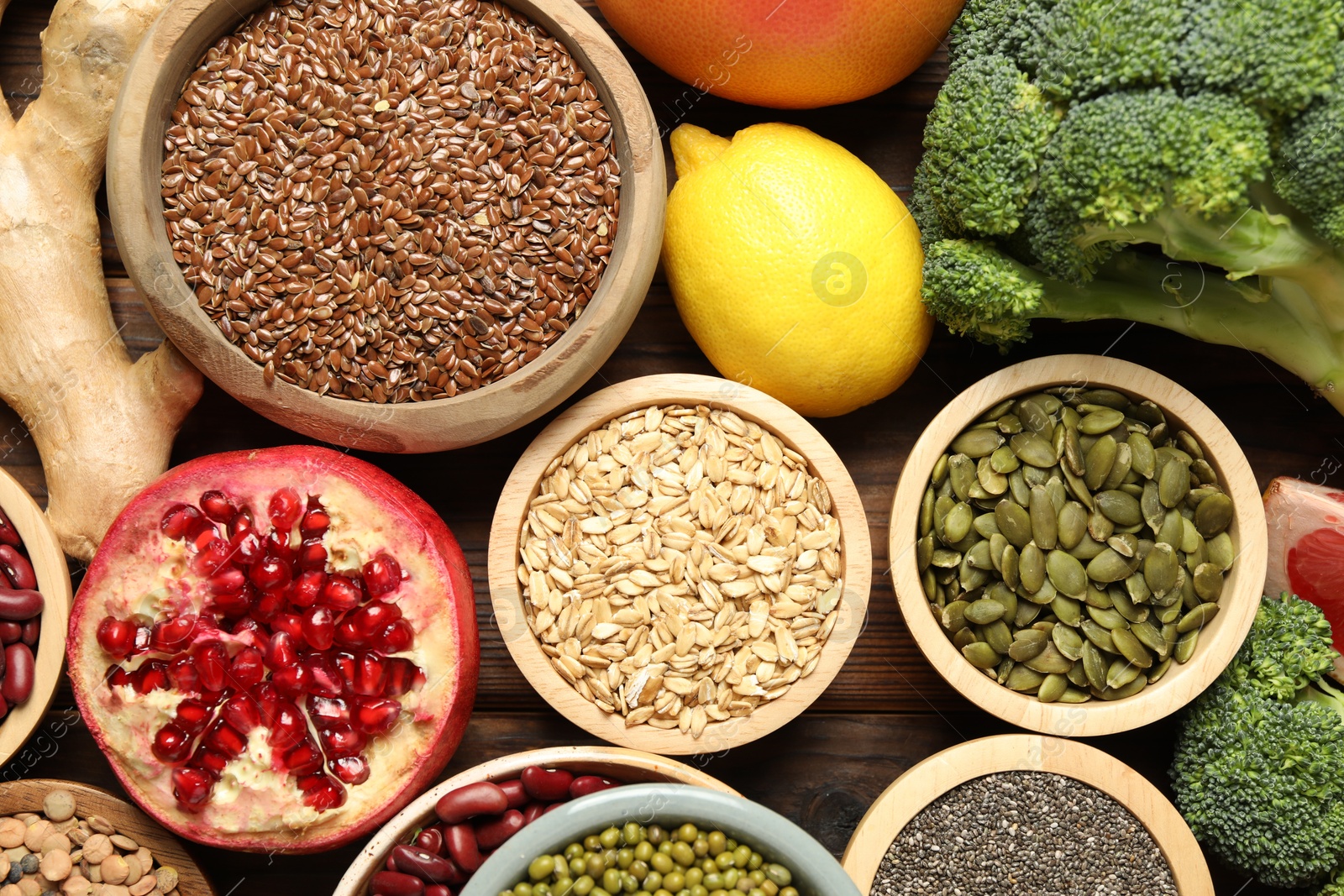 Photo of Different superfood products on wooden table, closeup