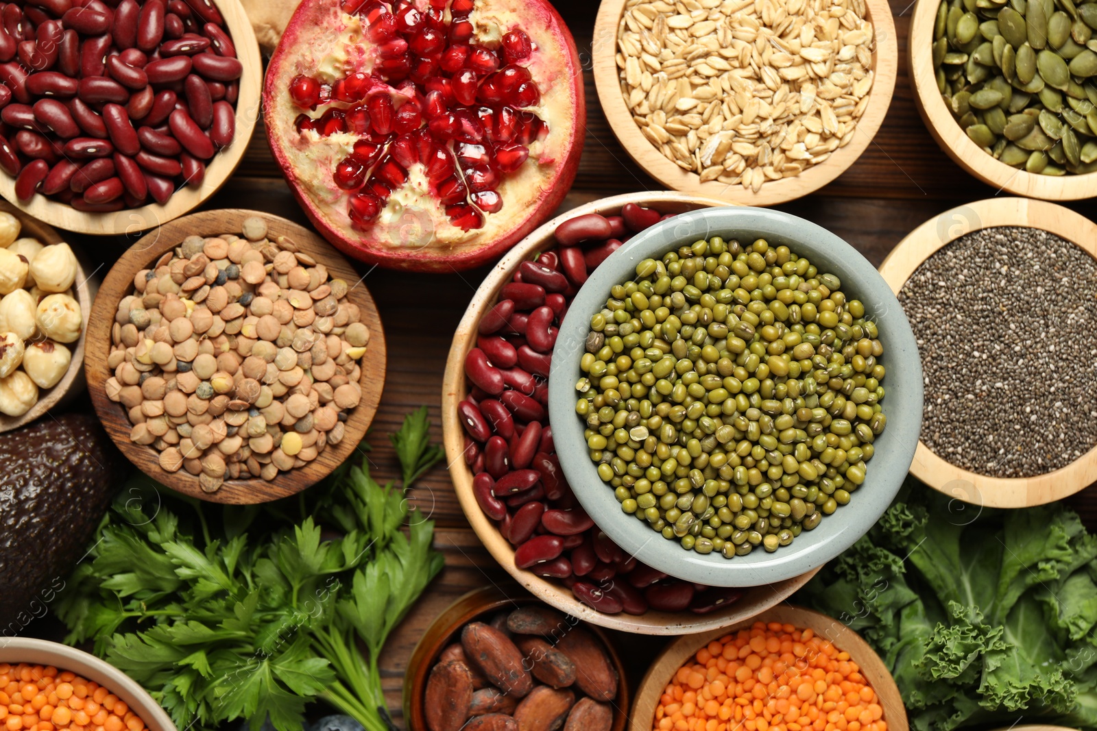 Photo of Different superfood products on wooden table, closeup